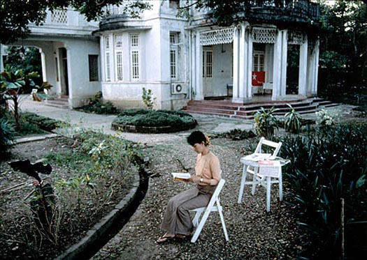 Daw Aung San Suu Kyi, nonviolent activist and winner of the 1991 Nobel Peace Prize, reads in her yard where she was under house arrest for 6 years